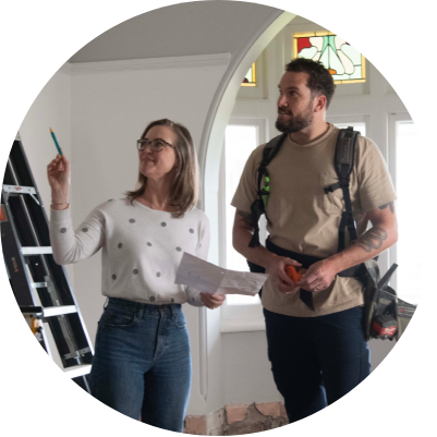 Woman showing tradie around house to begin home renovations